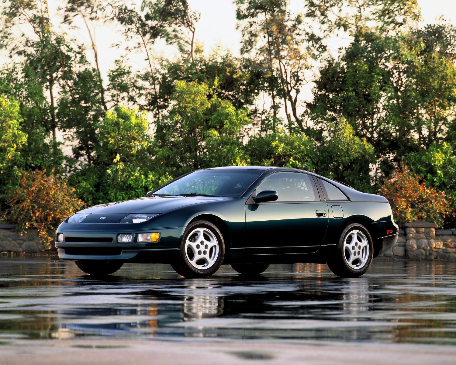 Black 1991 Nissan 300ZX in front of trees with wet road